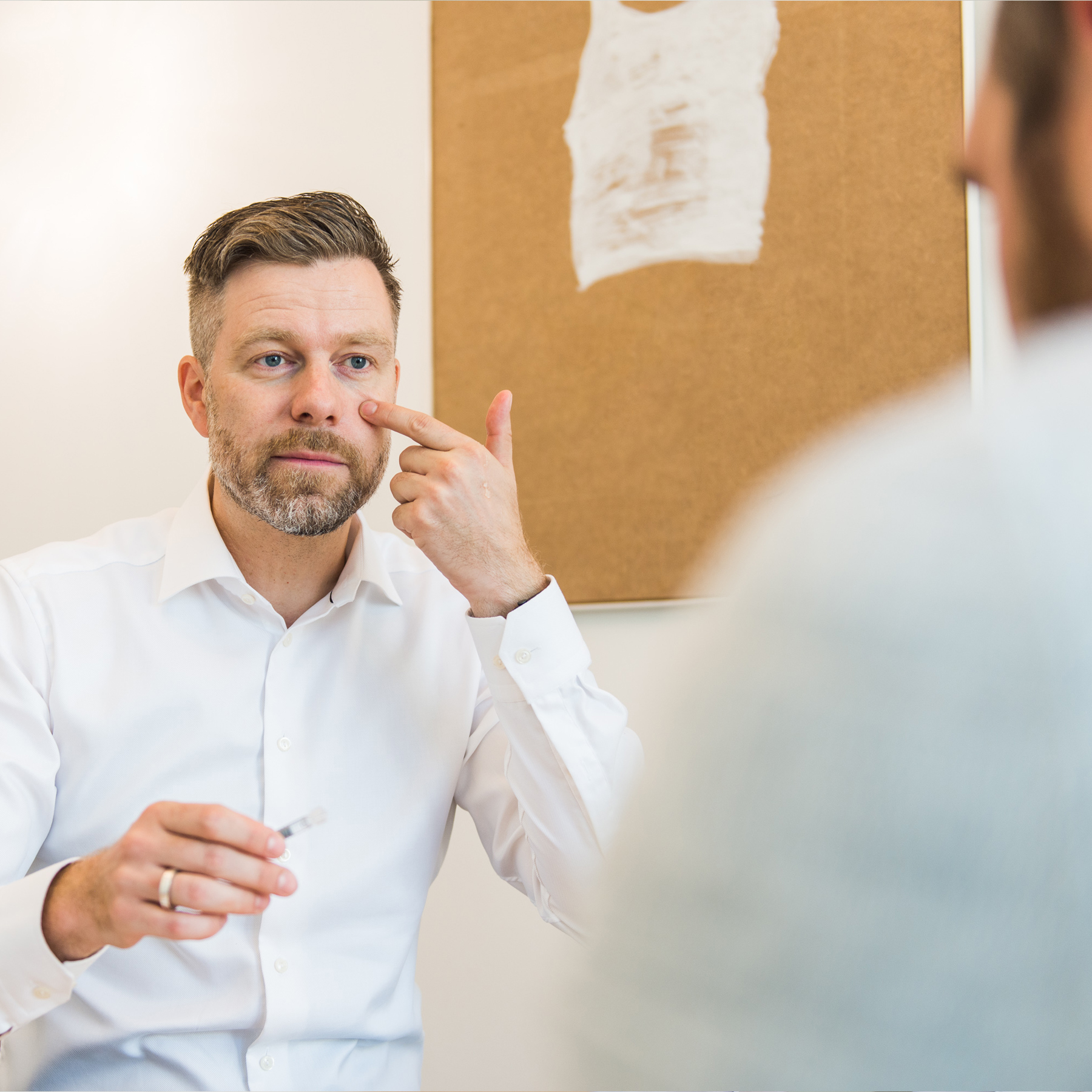 Dr. Stephan Frantzen points out facial regions during a consultation